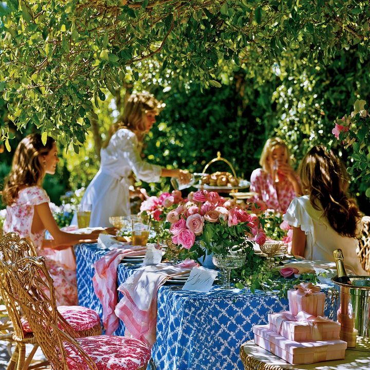 A bridal shower brunch on a sunlit garden terrace surrounded by pink flowers